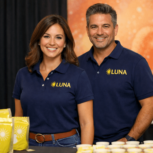 Business team wearing navy embroidered polo shirts with logo at promotional booth Business team wearing navy embroidered polo shirts with logo at promotional booth