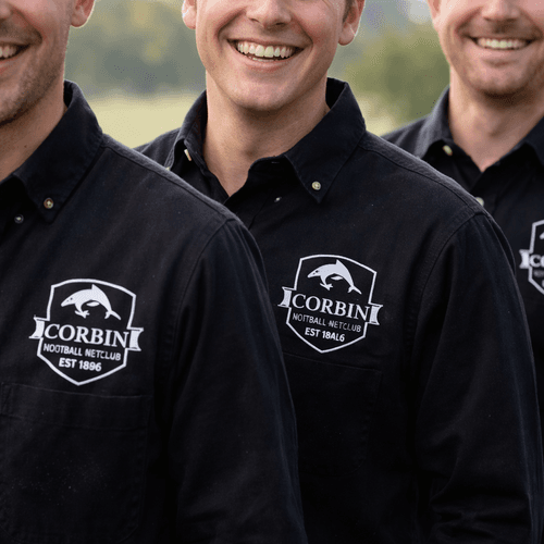 Team wearing black embroidered work shirts with Corbin logo outdoors Team wearing black embroidered work shirts with Corbin logo outdoors