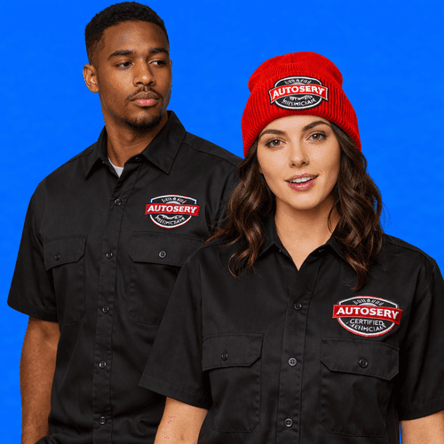 Two employees wearing black work shirts with embroidered logo Two employees wearing black work shirts with embroidered logo